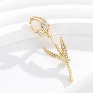 Élégante broche tulipe dorée avec strass en cristal blanc sur fond blanc minimaliste