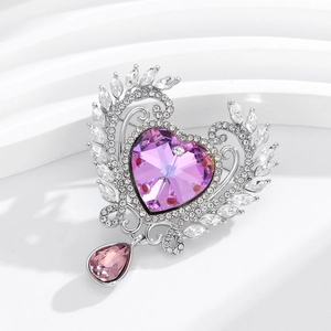 Elegant silver heart brooch featuring a purple crystal stone and a teardrop pendant