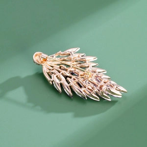 Back view of a gold wheat leaf brooch showing the secure pin clasp and layered metal texture