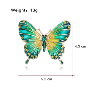 Elegant gold butterfly brooch with green enamel wings and dimensions 5.2cm x 4.3cm