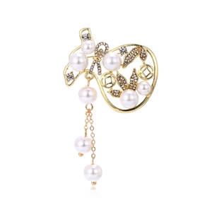 Broche sac de chance en perles exquises avec glands dorés et strass sur fond blanc