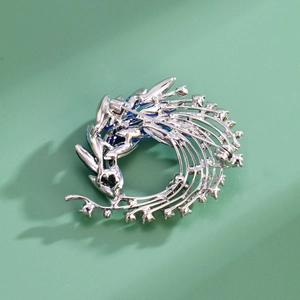 Elegant silver phoenix tail brooch with blue crystals and vintage floral design