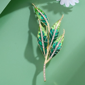 Exquisite green enamel willow leaf brooch with sparkling crystals on golden metal base