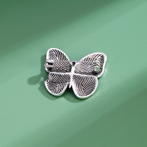 Vintage butterfly brooch in antique silver finish with textured wings and pin clasp
