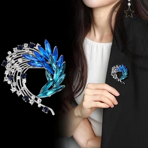 Elegant silver feather brooch with blue gradient crystals and velvet luster finish