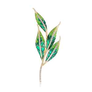 Green enamel willow leaf brooch with gold metal frame and sparkling crystal accents