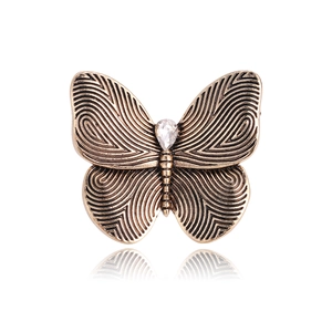 Vintage bronze butterfly brooch with spiral wing textures and teardrop rhinestone