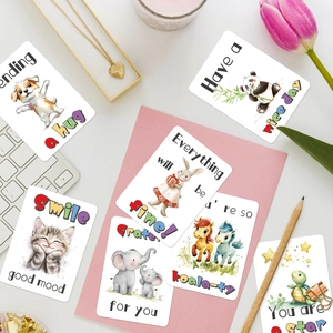 Flat lay of watercolor animal greeting cards with motivational quotes and cute illustrations