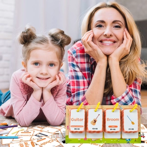 Parent and child playing with interactive English educational flip cards on carpet