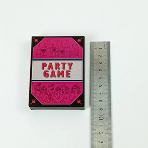 Close-up of pink and black party game card box with size scale showing 9.5cm length