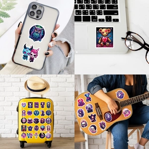 Detail of assorted purple gothic stickers on laptops and suitcases for creative DIY decor