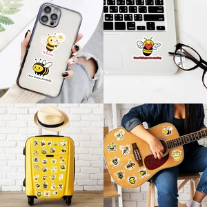 Detail view of waterproof cartoon bee stickers applied on laptop and mobile phone covers