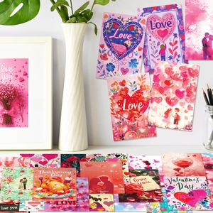 Artistic detail of pink Valentine's Day greeting cards with floral and heart designs
