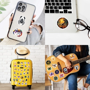 Waterproof Scorpio vinyl stickers shown on laptop, phone, suitcase, and guitar