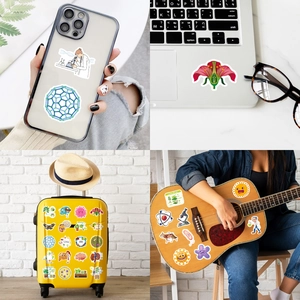 Detailed science stickers showing biological models on laptop, phone case and guitar