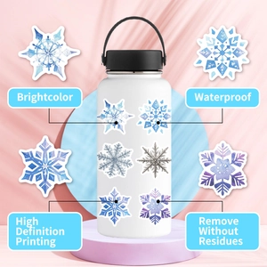 Waterproof blue snowflake stickers shown on a white tumbler with high definition printing