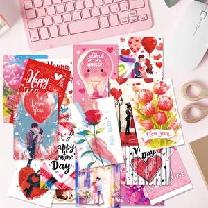 Flat lay of Valentine cards with pink heart balloons and rose bouquets on a desk