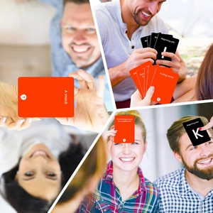 Macro view of couple interactive game cards with red category themes and black letter cues
