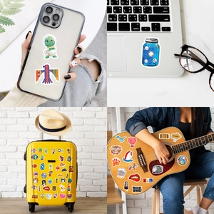 Waterproof graffiti stickers shown decorating a laptop, suitcase, guitar, and phone case