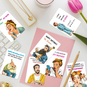 50-pack funny retro birthday greeting cards with vintage illustrations on a desk