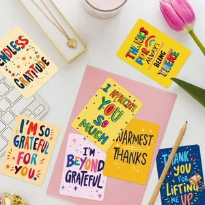 Graffiti style colorful thank you cards set with envelopes and tulip on white desk