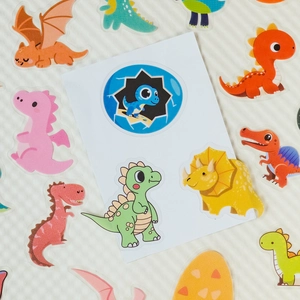 Detailed close-up of cute cartoon dinosaur PET stickers for scrapbooking and decoration