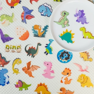 Detailed flat lay of cute waterproof dinosaur PET stickers in vibrant colors