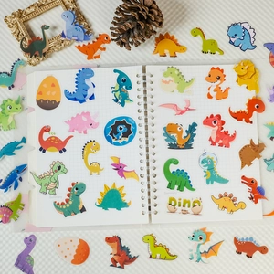 Detail of cute PET dinosaur stickers on a white binder showing various cartoon species