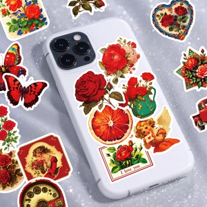 Detail of vintage red rose and butterfly stickers on a phone case for DIY scrapbooking