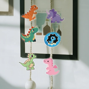 Detail showing 6 colorful cartoon dinosaur PET stickers on a minimalist white wall