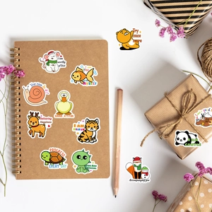 Cute animal reward stickers with slogans displayed on a notebook and gift box
