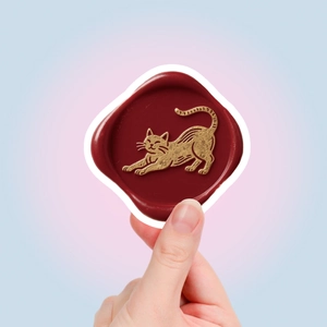 Detailed close-up of a burgundy wax seal sticker featuring a gold cat relief pattern