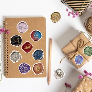 Detailed view of vintage wax seal stickers in various colors on a kraft notebook
