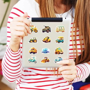 Cartoon vehicle stickers on a tablet showing trucks, excavators and colorful RV designs
