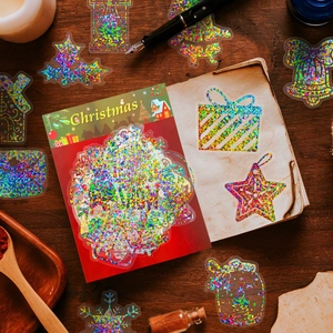 Macro detail of holographic Christmas PET stickers with vintage metallic foil on wood surface