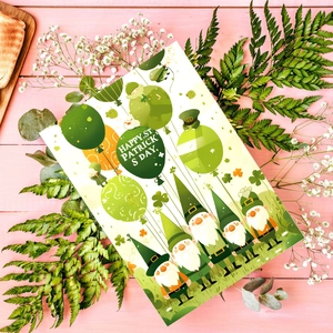 Detail of St. Patrick's Day card with gnomes and balloons on a rustic wood background