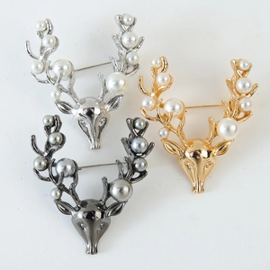 Three Christmas reindeer brooches in gold, silver and gunmetal with elegant pearls