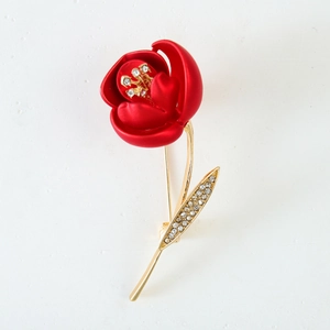 Elegant vintage red rose brooch with matte petals and sparkling crystal accents in gold