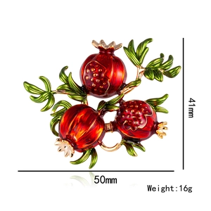 Detail view of red pomegranate enamel brooch with dimensions 50mm x 41mm and 16g weight