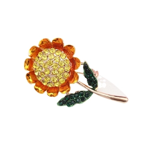 Broche tournesol scintillante avec cristaux jaunes et feuilles vertes sur base or rose