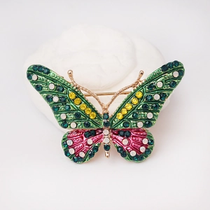 Spilla a farfalla vintage in smalto verde con strass colorati su pietra bianca