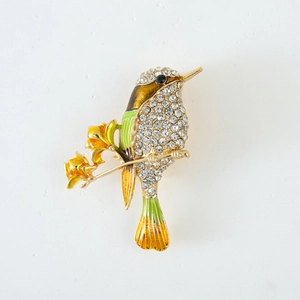 Charming gold bird brooch with yellow enamel, green accents and sparkling rhinestones