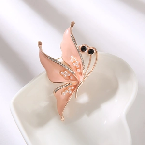 Elegant gold butterfly brooch with pink enamel wings and small white pearls