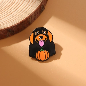 Cute Halloween enamel pin featuring a black dog holding an orange pumpkin accessory
