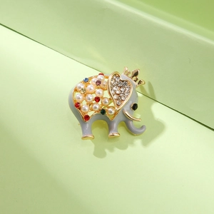 Elegant gold elephant brooch with colorful rhinestones, pearls, and a crown detail