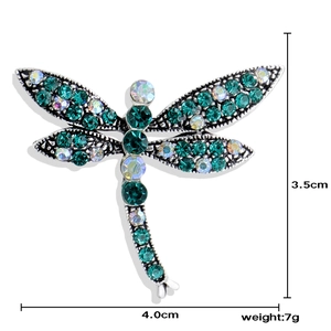 Vintage dragonfly brooch with green emerald crystals and colorful rhinestones in silver finish