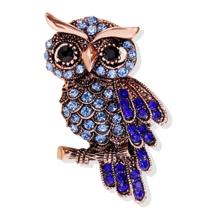 Elegant owl brooch with blue rhinestones on rose gold branch, creative vintage jewelry