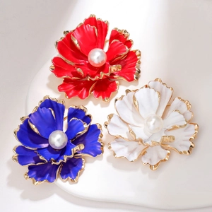 Elegant gold-edged flower brooches with pearls in red, blue, and white floral designs