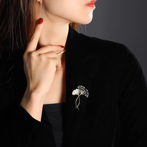 Élégante broche en forme de feuille de ginkgo sertie de cristaux sur un blazer