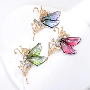Close-up of ballet dancer butterfly brooches in three colors with crystal and gold accents